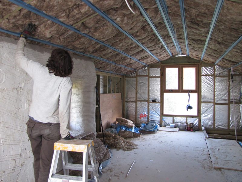 Sue Installing Insulation in Attic Roof - Strawbale House Build